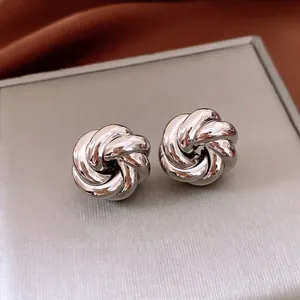 Modern silver metallic swirl flower earrings with a high-polished mirror finish