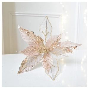 Detail of glittery champagne gold poinsettia flower with mesh petals for Christmas decor