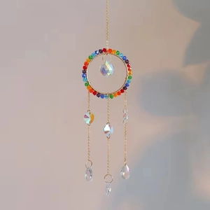 Rainbow crystal suncatcher with golden ring, colorful beads, and faceted glass ball pendant