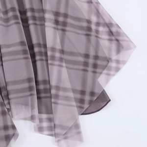 Detailed macro view of layered purple and grey plaid mesh fabric with sheer texture
