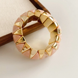 Detail of geometric gold and pink marble resin blocks on an elasticated bracelet