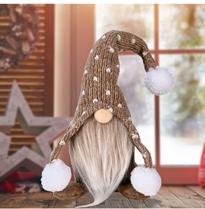 Detail von Weihnachtsgnom mit gestrickter gepunkteter Mütze und Plüschbart auf Tisch