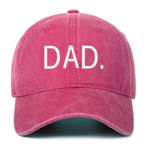 Macro view of washed cotton fabric and white DAD embroidery on a rose pink baseball cap