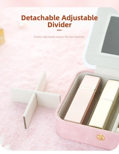 Pink suede jewelry box detail showing removable divider and built-in vanity mirror