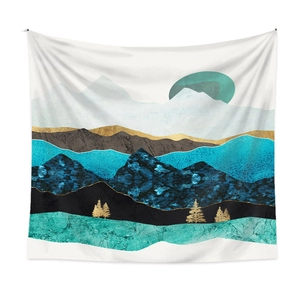 Detail of modern abstract tapestry featuring blue mountains, gold trees and sun silhouette