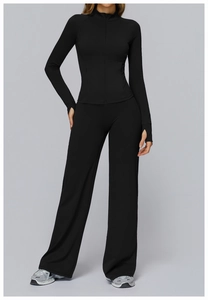 Macro detail of black yoga set featuring stand collar jacket and wide-leg sports trousers