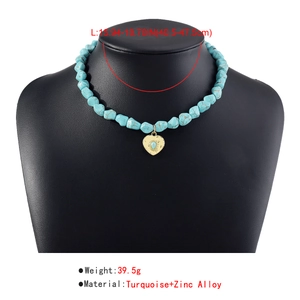 Detail of bohemian turquoise beaded necklace with heart pendant on display stand