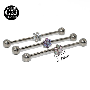 Detailed macro view of G23 titanium industrial barbells with opal and zircon flowers