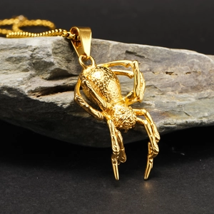Gothic punk gold spider pendant necklace made of stainless steel on dark rock