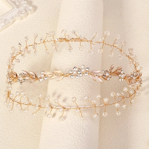 Detailed view of handmade bridal headbands with crystal beads and golden metallic leaves