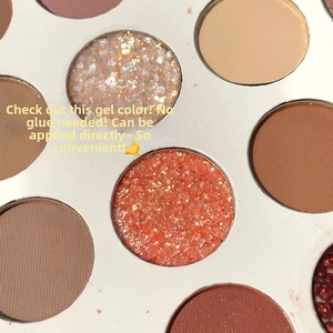 Macro detail of glitter gel and matte eyeshadow textures in a 26-color makeup palette