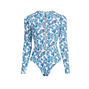 Detail of long sleeve swimsuit featuring blue sea life print and gold zipper front