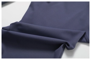 Detailed close-up of navy blue yoga leggings fabric with seamless four-needle six-thread stitching