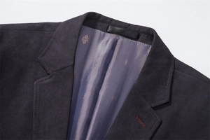 Detail of the corduroy collar and printed lining stitching on a casual men jacket
