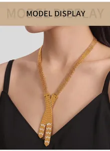 Detailed view of layered 18K gold plated cross pendant necklace on model with crystals
