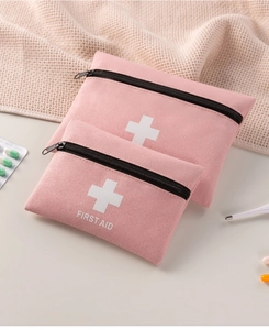 Pink portable first aid storage bags in two sizes with white cross and text on soft fabric