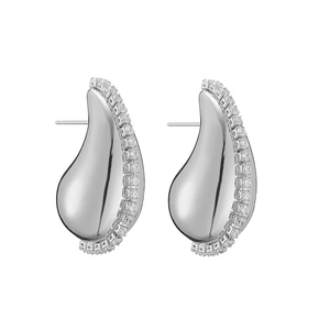 Macro detail of silver drop earrings with polished finish and pavé cubic zirconia