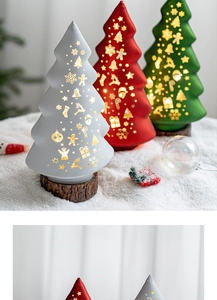 Detail of glowing Christmas tree night light with star cutouts and warm LED on wood base