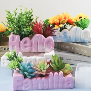 Detail of Hello and Familia letter shaped flower pots with marble texture finish