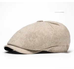 Detailed side view of beige newsboy cap showing textured tweed fabric and button top