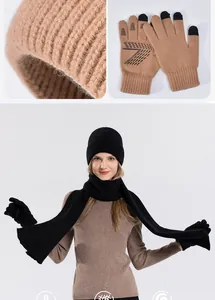 Close-up of winter knit set including warm beanie, scarf and touch screen gloves