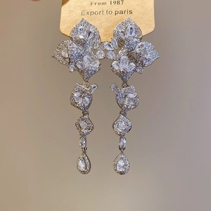 Detail of elegant leaf tassel earrings with sparkling cubic zirconia drops in silver finish