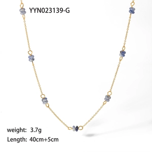 Detailed view of a gold-plated necklace with purple faceted beads and extension chain