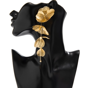 Macro shot of large golden ginkgo leaf earrings with layered petals and fine linear texture