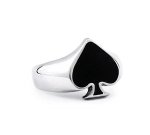 Macro view of polished stainless steel ring featuring a black spade enamel emblem detail