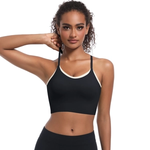 Detail of black sports bra with cream contrast trim and thin elastic straps