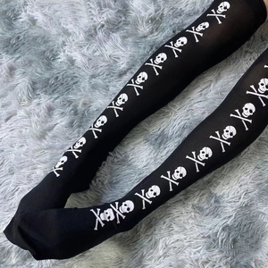 Halloween cosplay black thigh high socks with white skull and crossbones print on plush rug