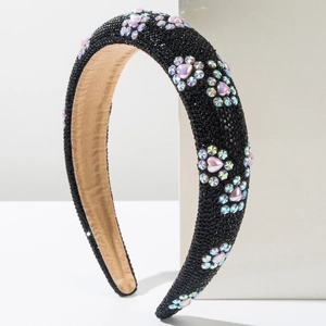 Detail of wide black headband with colorful rhinestone flower patterns and padded texture