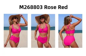 Detail view of high-waist rose red bikini set with metallic ring and pleated accents