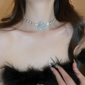 Sparkling silver diamond rose flower necklace choker shown on a model with shimmering light