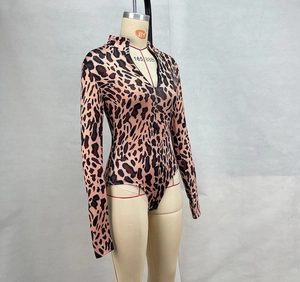 Detail of leopard print bodysuit featuring a front zipper and mock neck stand-up collar