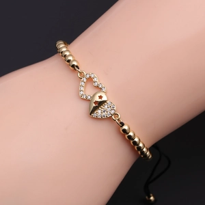 Detail of gold-plated double heart bracelet with cubic zirconia and star cutout