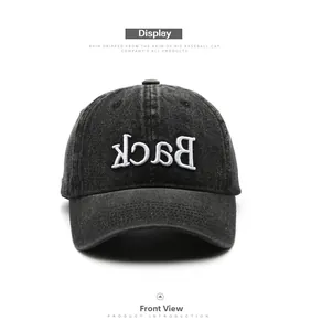Front view of washed denim baseball cap featuring white 3D embroidered Back lettering