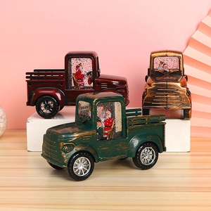 Close-up of vintage Christmas water globe lanterns in red, green and bronze truck designs