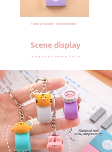 Mini cartoon animal stapler with metal keychain and extra staples shown in hand