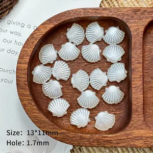 Macro detail of 13x11mm pearl white scallop acrylic beads for DIY jewelry making