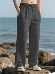 Detail of high waist elastic drawstring on dark grey ribbed knit wide leg trousers