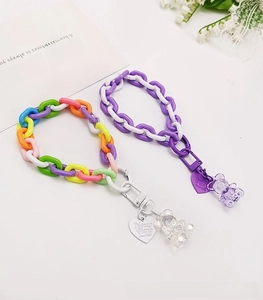 Detailed shot of colorful beaded phone straps with jelly resin bear charms and metal clasps
