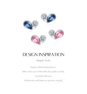 Macro shot of silver heart studs with blue and pink crystals and cubic zirconia