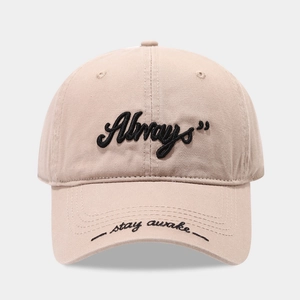 Detailed close-up of Always and stay awake embroidery on a beige cotton baseball cap