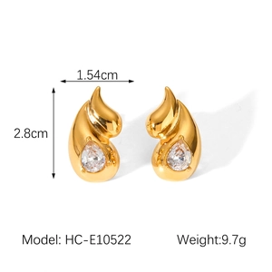 Detail view of gold drop earrings with dimensions 2.8cm by 1.54cm and sparkling crystals