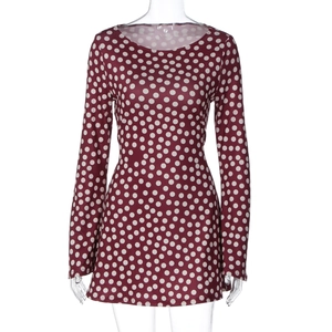 Detailed view of the red polka dot long sleeve dress fabric and slim fit design
