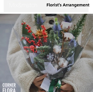 Detail of Christmas bouquet with red berries, cotton and snowflake cellophane wrap
