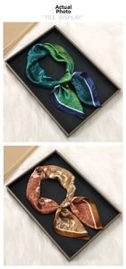 Detail showing vintage paisley print satin scarves in blue and orange on a display tray