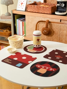 Close-up of cute mushroom diatomite coasters and heat-resistant mats on a white table