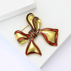 Vintage red enamel bow brooch with gold-plated alloy finish for elegant women's styling